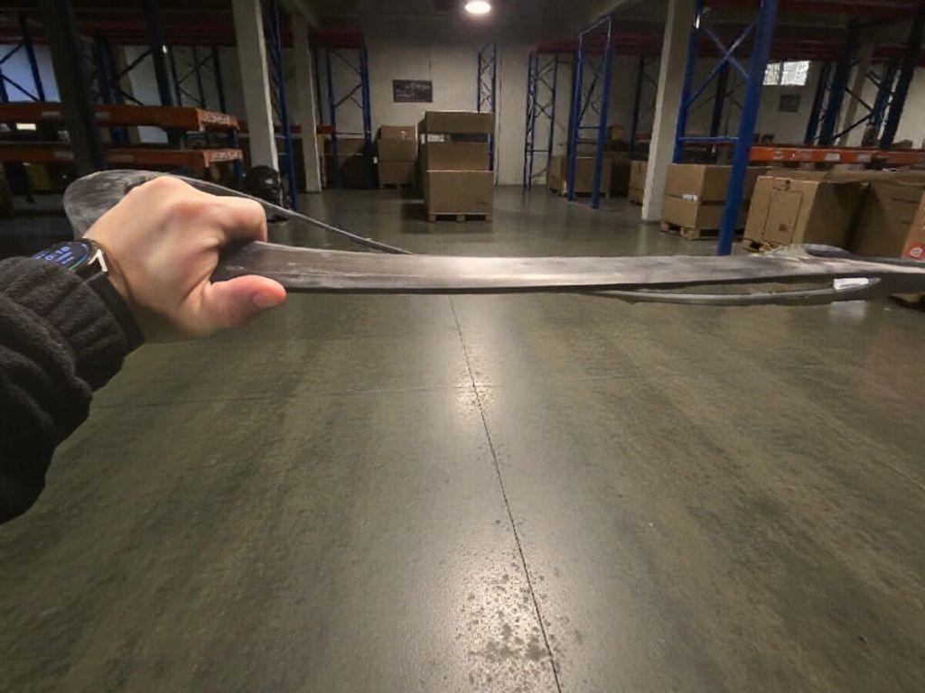Worker holding a large-diameter metal-reinforced flange gasket in the warehouse