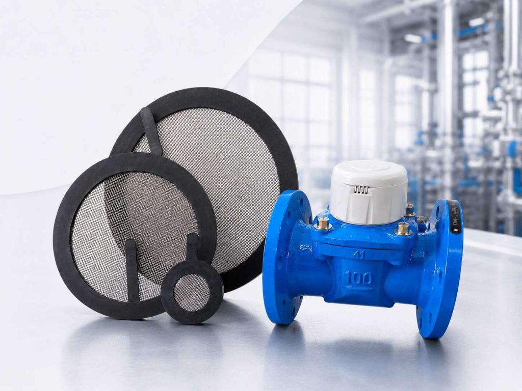 Strainer flange gaskets with stainless steel mesh next to a flanged water meter