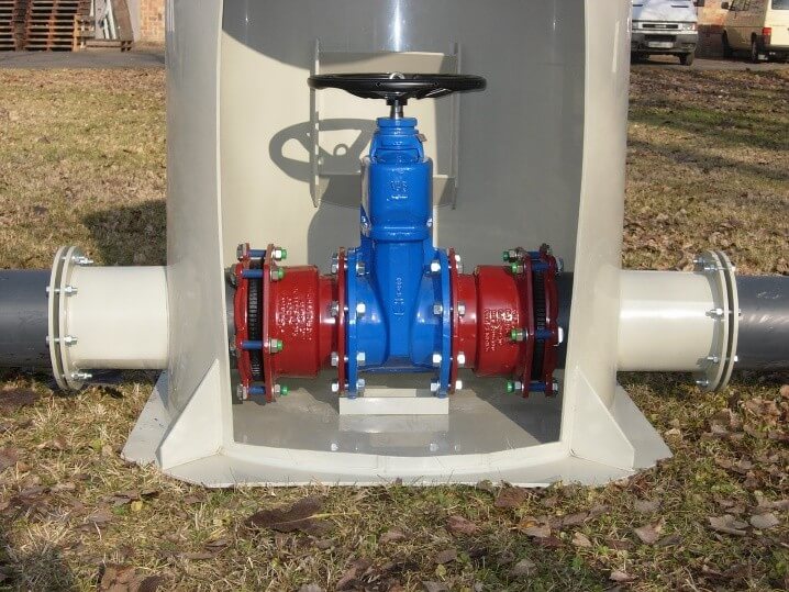Custom welded plastic tank with valve assembly, installed outdoors